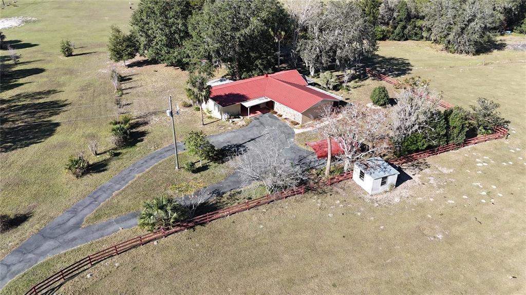 2155 Southeast County Highway 484 Belleview, FL 34420 - Photo 35 of 41 an aerial view of a house with a yard and large trees
