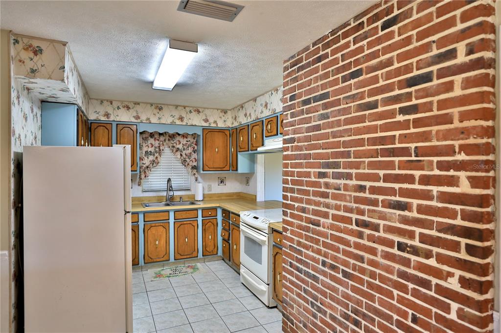 2155 Southeast County Highway 484 Belleview, FL 34420 - Photo 7 of 41 a kitchen with stainless steel appliances a sink and cabinets
