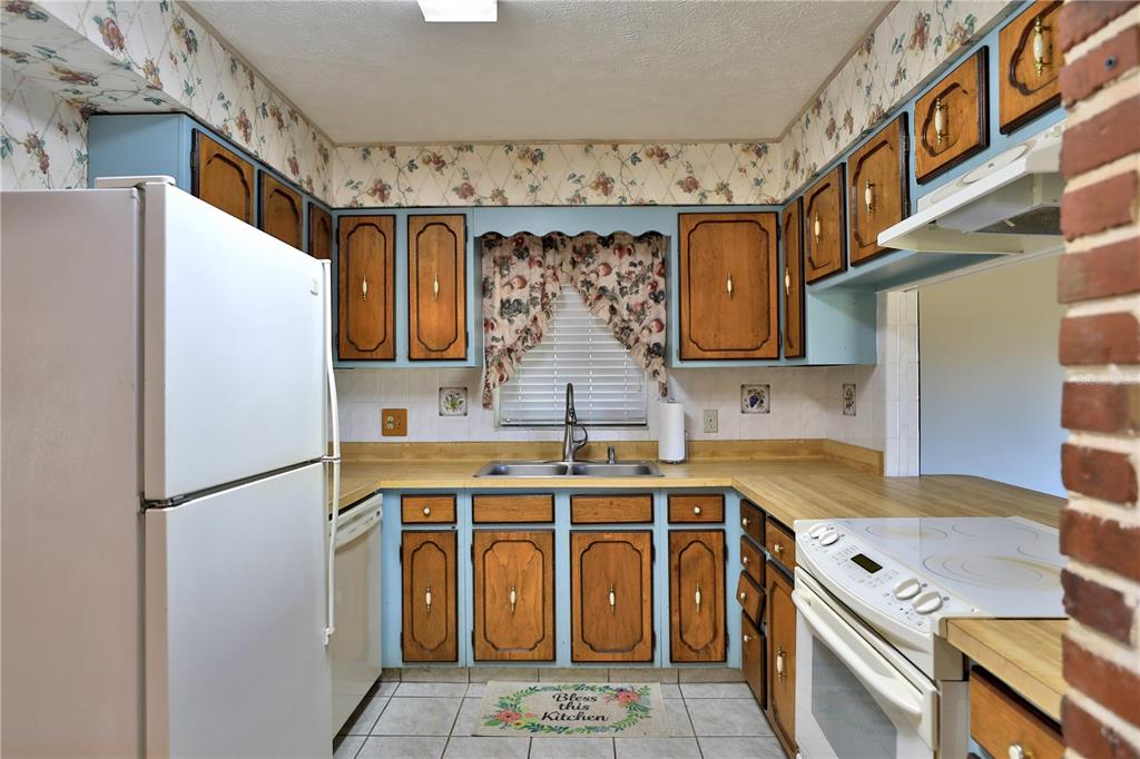 2155 Southeast County Highway 484 Belleview, FL 34420 - Photo 8 of 41 a kitchen with stainless steel appliances granite countertop a refrigerator a sink and a stove