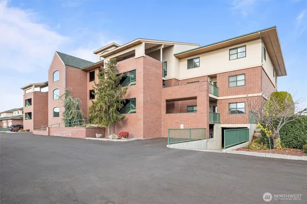 a kitchen with stainless steel appliances white cabinets and wooden floor