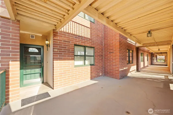 a view of a brick house with many windows