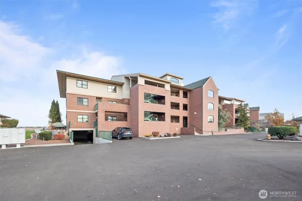 a kitchen with granite countertop a sink and a wooden floor