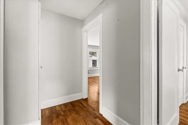 a view of an empty room and wooden floor