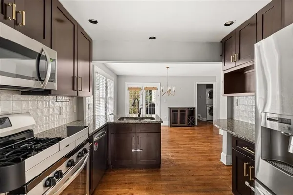 a kitchen with stainless steel appliances a refrigerator a stove and a sink