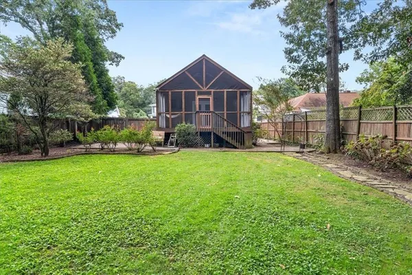 a view of a house with a backyard