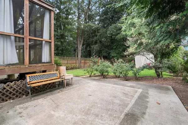 a view of a yard with plants and trees