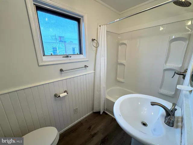 a bathroom with a sink mirror and toilet