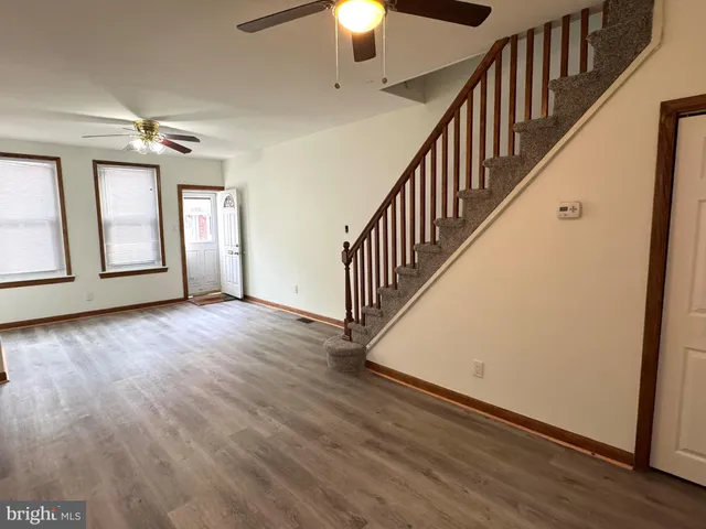 wooden floor in an empty room with a window and wooden floor
