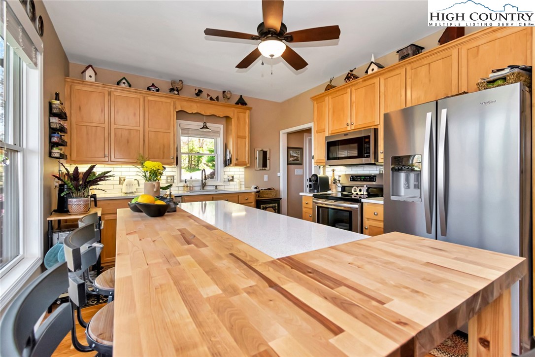 190 Summit Park Circle Boone, NC 28607 - Photo 11 of 50 a large kitchen with a table chairs refrigerator and a window