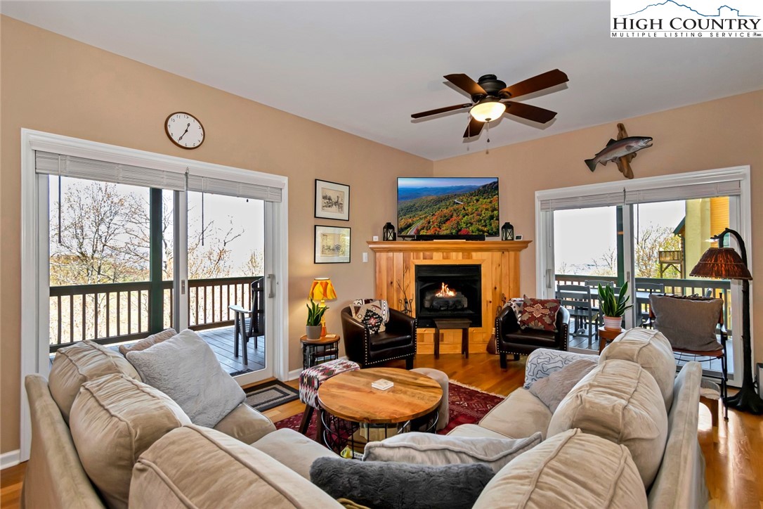 190 Summit Park Circle Boone, NC 28607 - Photo 15 of 50 a living room with furniture a fireplace and a large window