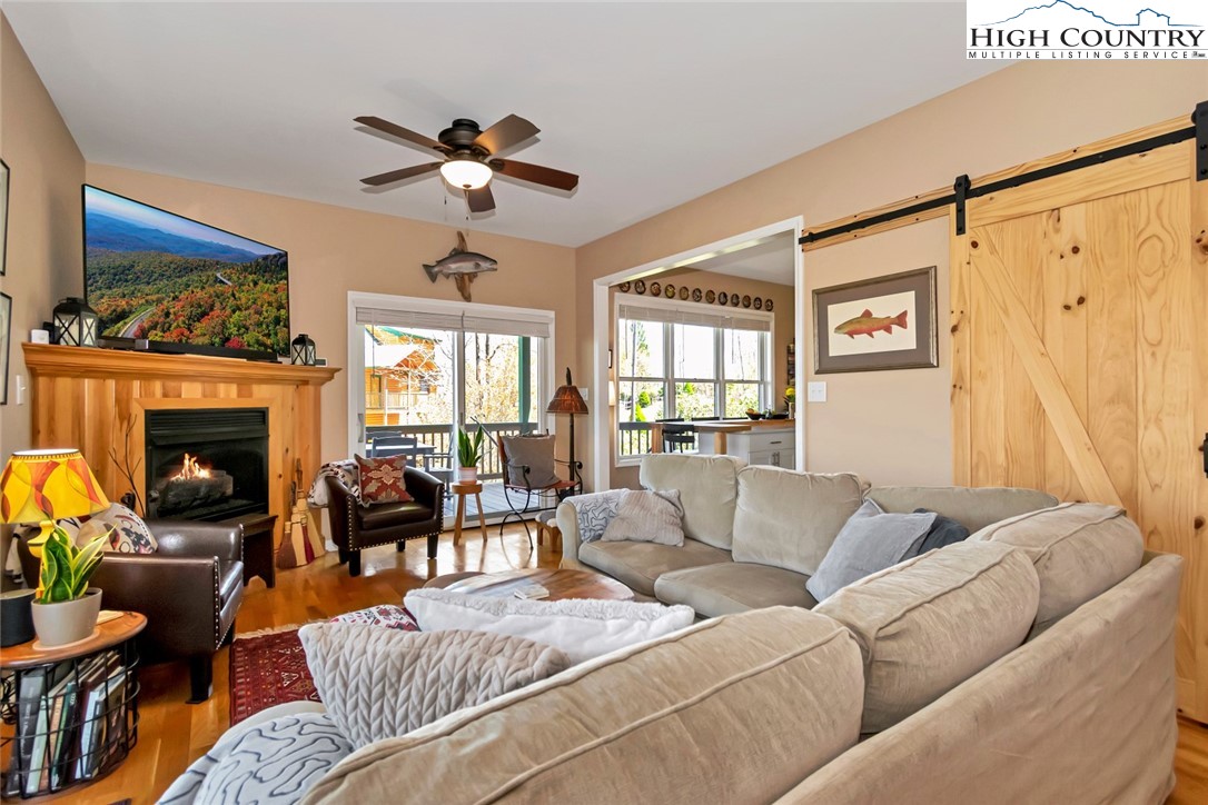 190 Summit Park Circle Boone, NC 28607 - Photo 17 of 50 a living room with furniture a fireplace and a chandelier