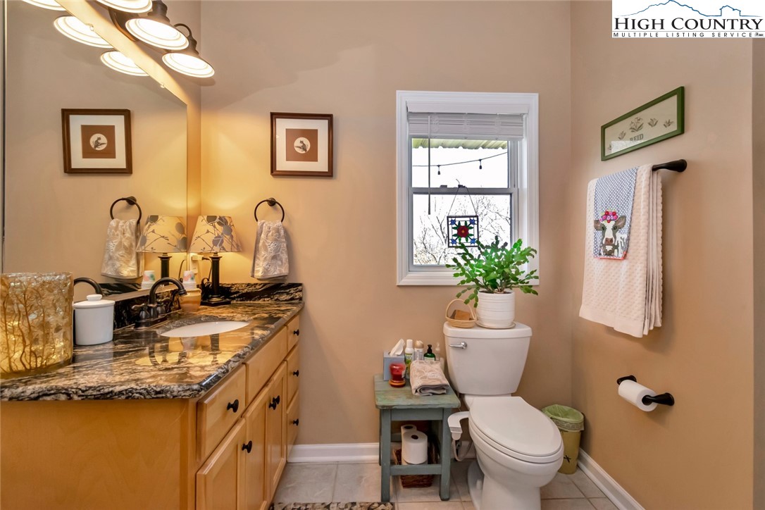 190 Summit Park Circle Boone, NC 28607 - Photo 21 of 50 a bathroom with a granite countertop toilet sink and mirror