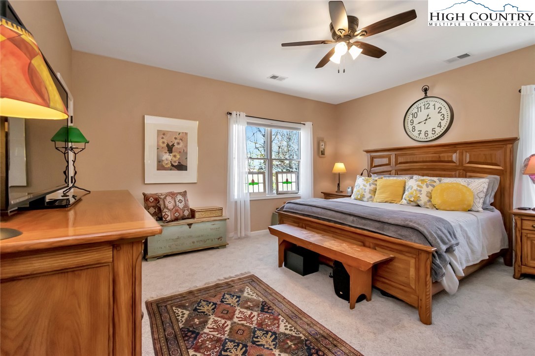 190 Summit Park Circle Boone, NC 28607 - Photo 25 of 50 a bedroom with a bed and a chandelier