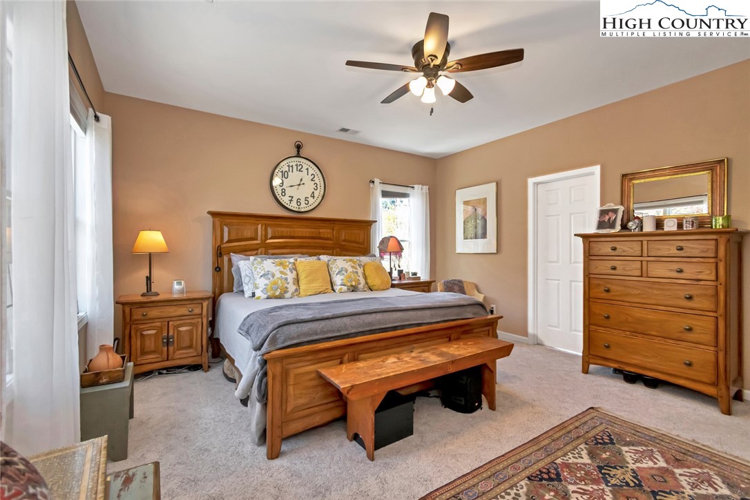 190 Summit Park Circle Boone, NC 28607 - Photo 27 of 50 a bedroom with a bed and a chandelier