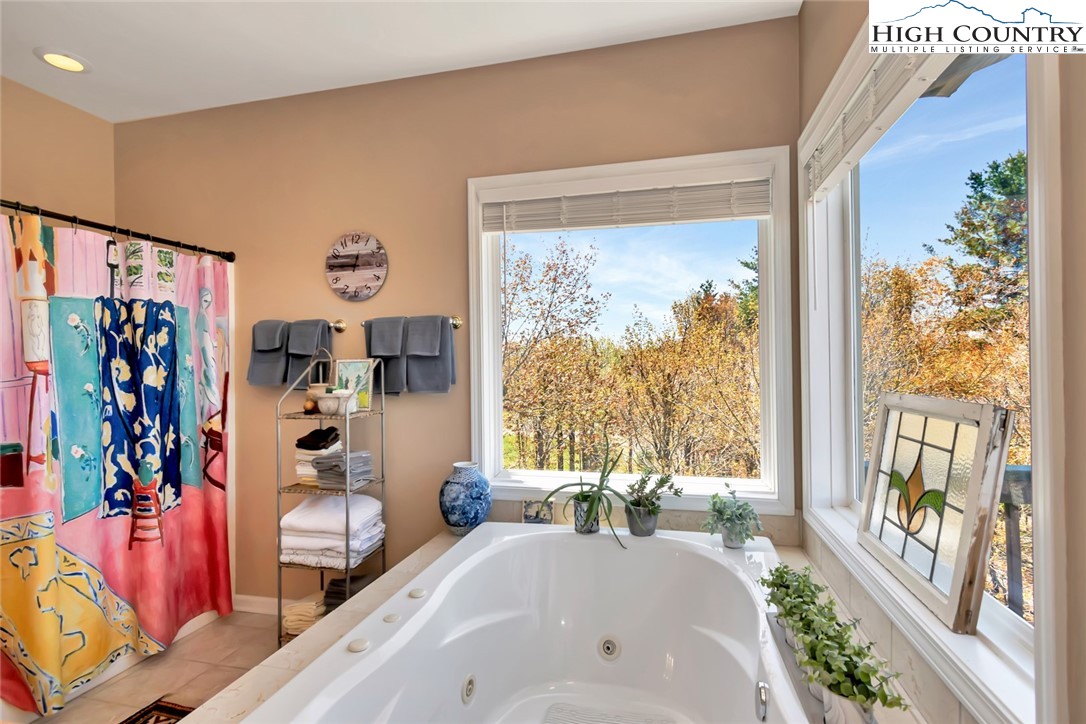 190 Summit Park Circle Boone, NC 28607 - Photo 29 of 50 a bath room with a large window and a bed
