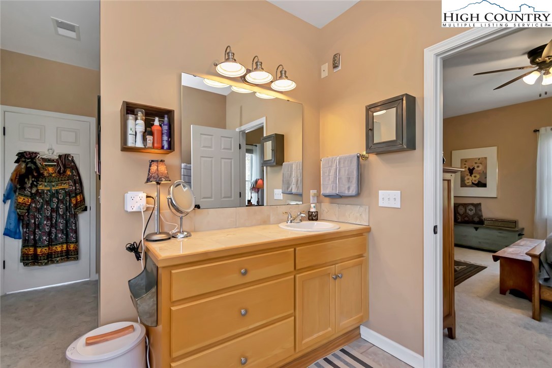190 Summit Park Circle Boone, NC 28607 - Photo 32 of 50 a en suite bathroom with a double vanity sink and a mirror
