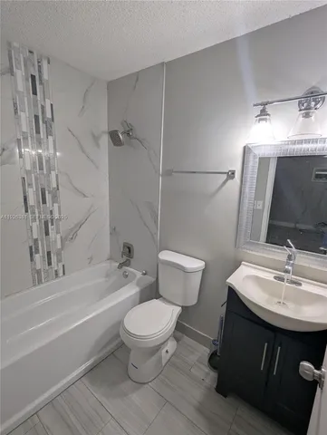 a bathroom with a sink toilet a mirror and shower