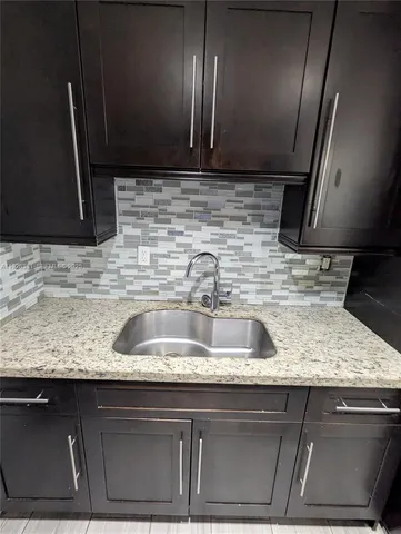 a kitchen with a sink and a microwave