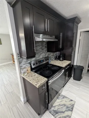 a kitchen with a sink stove and refrigerator