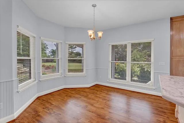 a kitchen with a sink a counter space and wooden floor