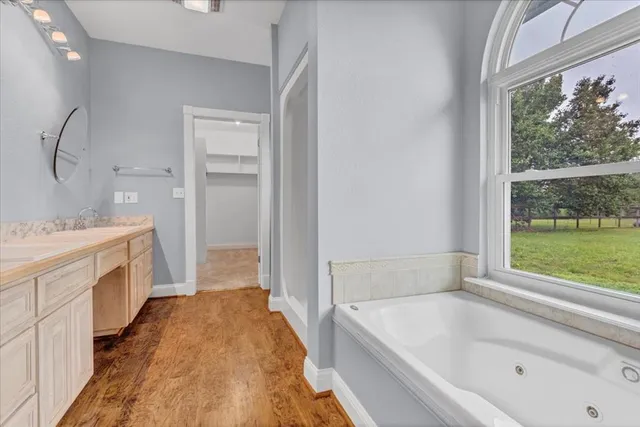 an empty room with a window and a ceiling fan