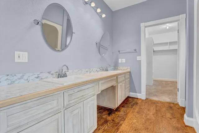 a bathroom with a tub sink and mirror