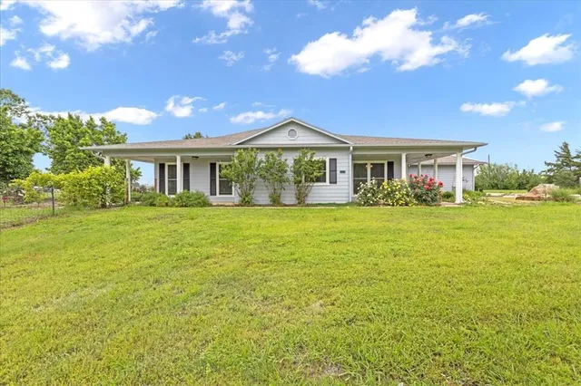 a front view of house with yard and green space
