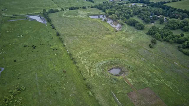 an aerial view of a house having yard patio and a yard