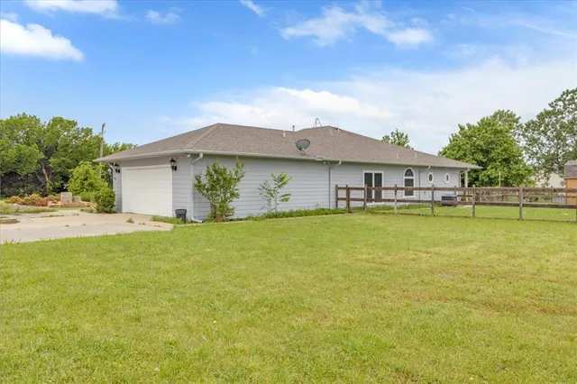 a house view with swimming pool in front of it
