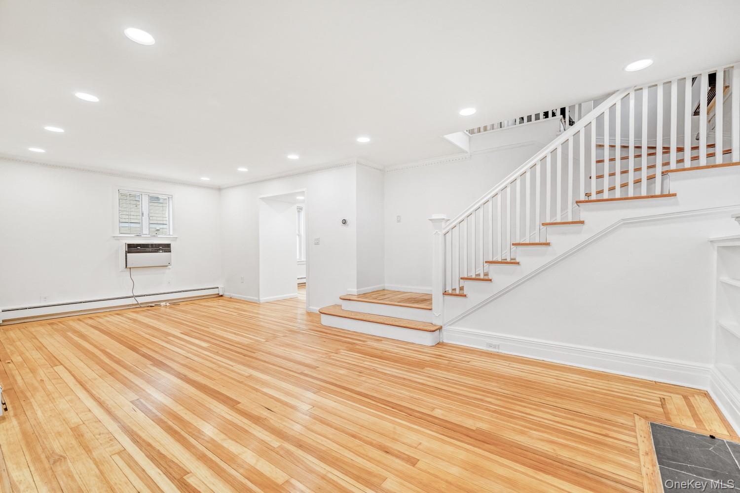 37 Keystone Place Hewlett, NY 11557 - Photo 11 of 45 a view of empty room with wooden floor and stairs