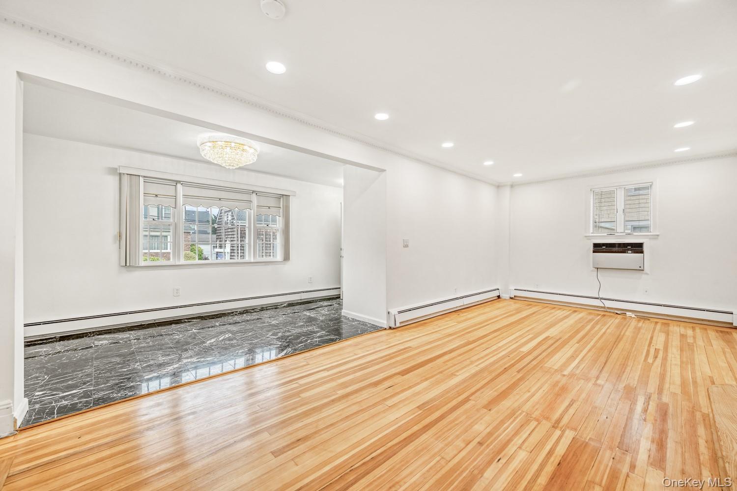 37 Keystone Place Hewlett, NY 11557 - Photo 12 of 45 a view of empty room with wooden floor and fan