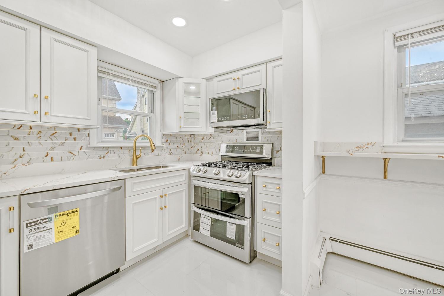 37 Keystone Place Hewlett, NY 11557 - Photo 14 of 45 a kitchen with cabinets stainless steel appliances and a window