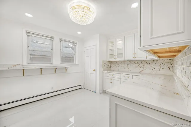 a kitchen with a cabinets and chandelier