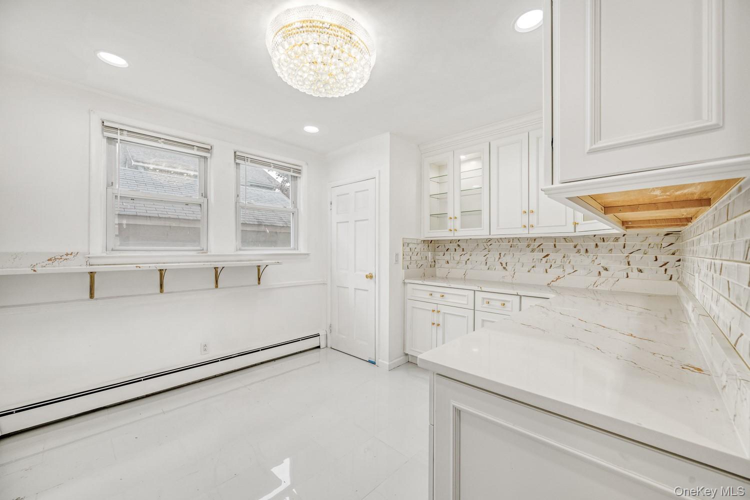 37 Keystone Place Hewlett, NY 11557 - Photo 16 of 45 a kitchen with a cabinets and chandelier