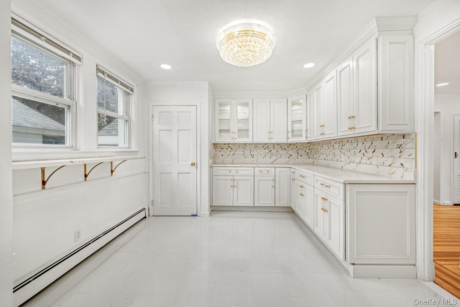 37 Keystone Place Hewlett, NY 11557 - Photo 17 of 45 a kitchen with granite countertop white cabinets and white appliances