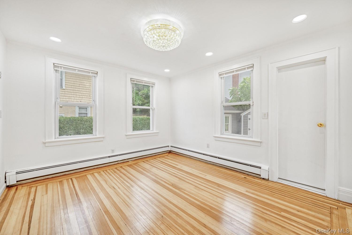 37 Keystone Place Hewlett, NY 11557 - Photo 19 of 45 an empty room with wooden floor and windows