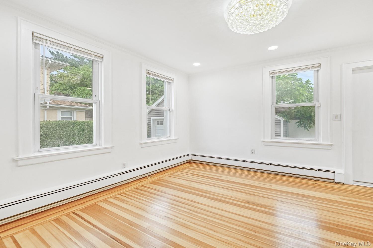 37 Keystone Place Hewlett, NY 11557 - Photo 20 of 45 an empty room with wooden floor and windows