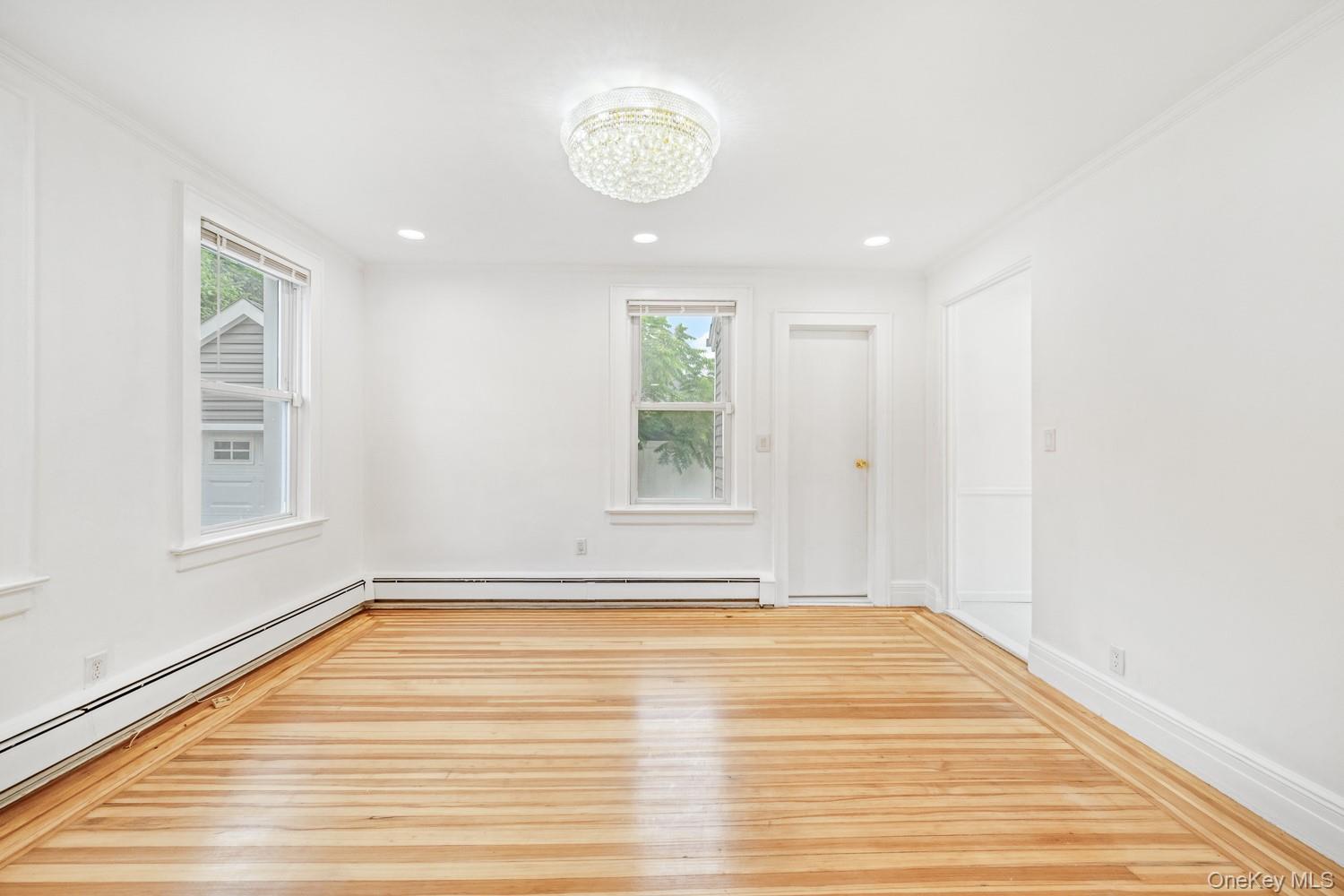 37 Keystone Place Hewlett, NY 11557 - Photo 21 of 45 a view of an empty room with wooden floor and a window
