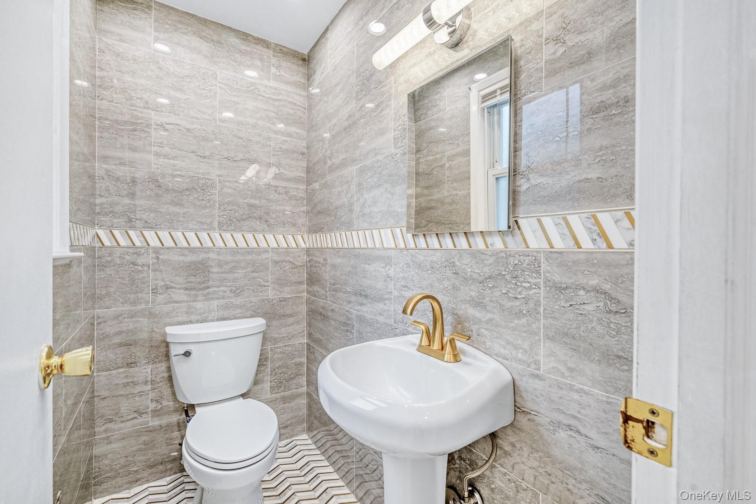 37 Keystone Place Hewlett, NY 11557 - Photo 22 of 45 a bathroom with a toilet sink and mirror