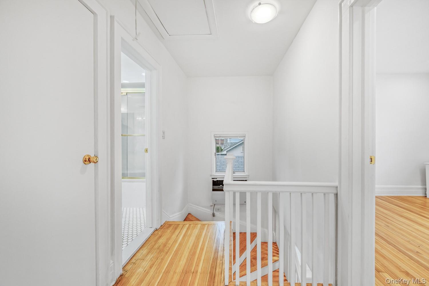 37 Keystone Place Hewlett, NY 11557 - Photo 23 of 45 a view of a bedroom with wooden floor and a bathroom