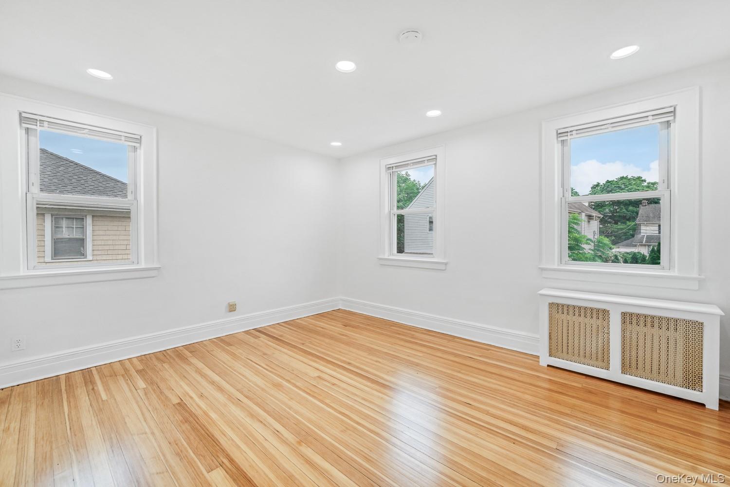37 Keystone Place Hewlett, NY 11557 - Photo 26 of 45 a view of empty room with wooden floor and fan