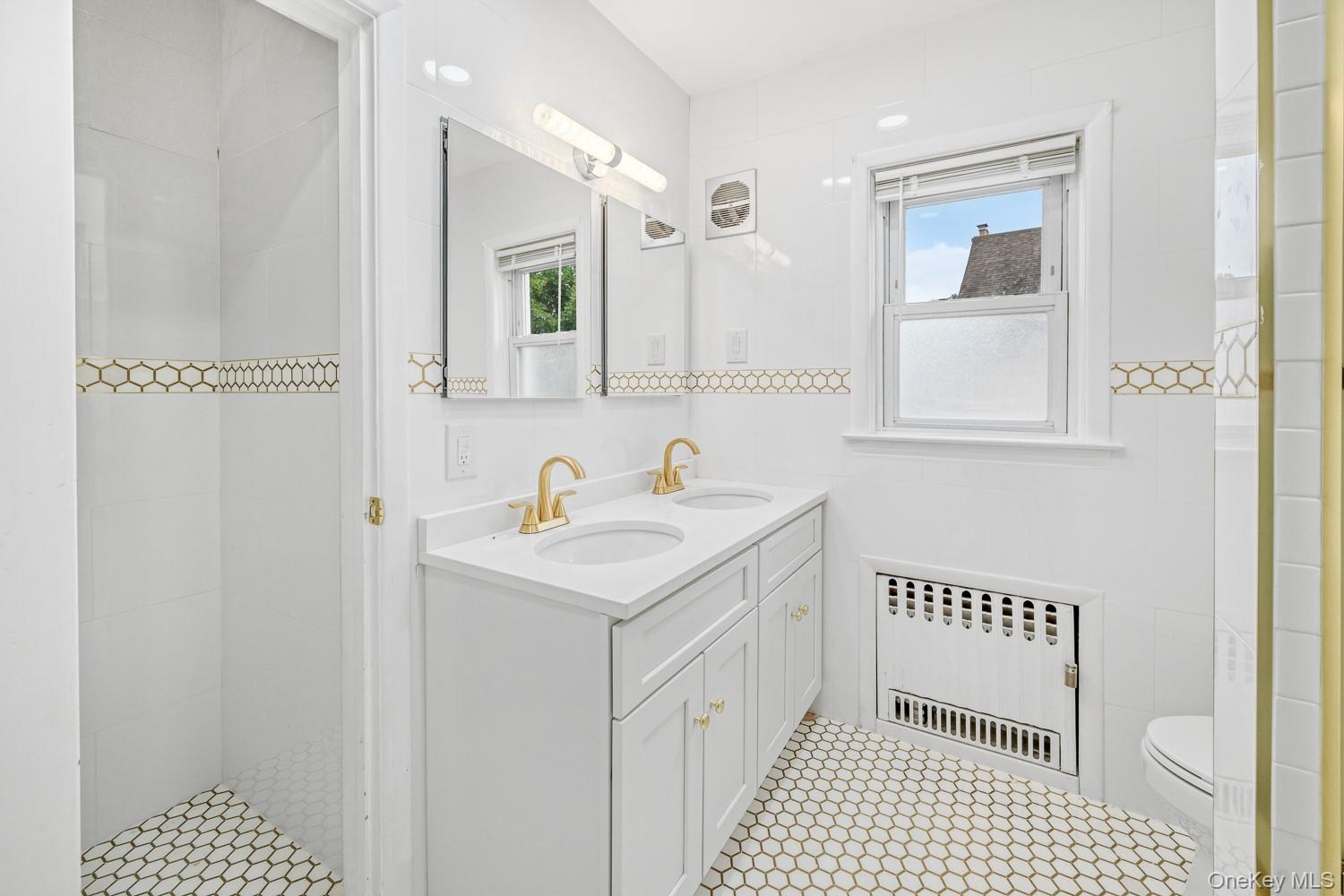 37 Keystone Place Hewlett, NY 11557 - Photo 28 of 45 a bathroom with a sink a toilet and a mirror