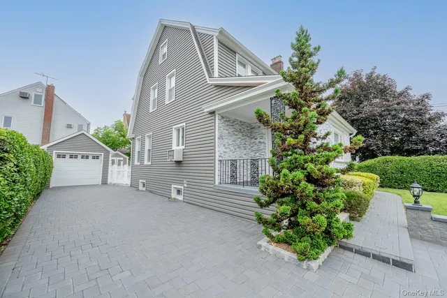 a view of a house with a yard and a garden
