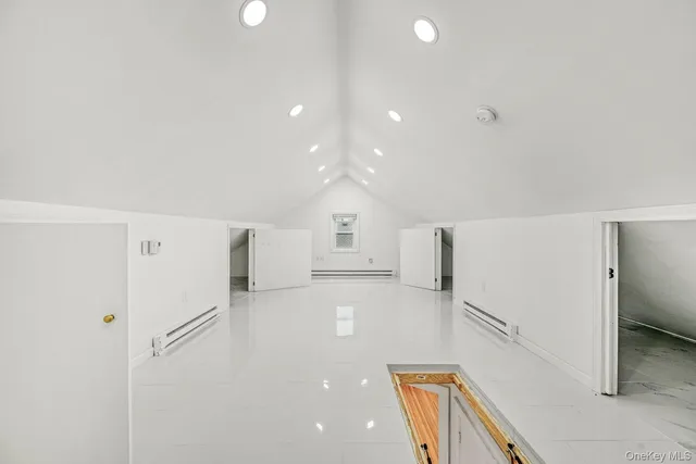 a view of a kitchen with a refrigerator and a stove top oven