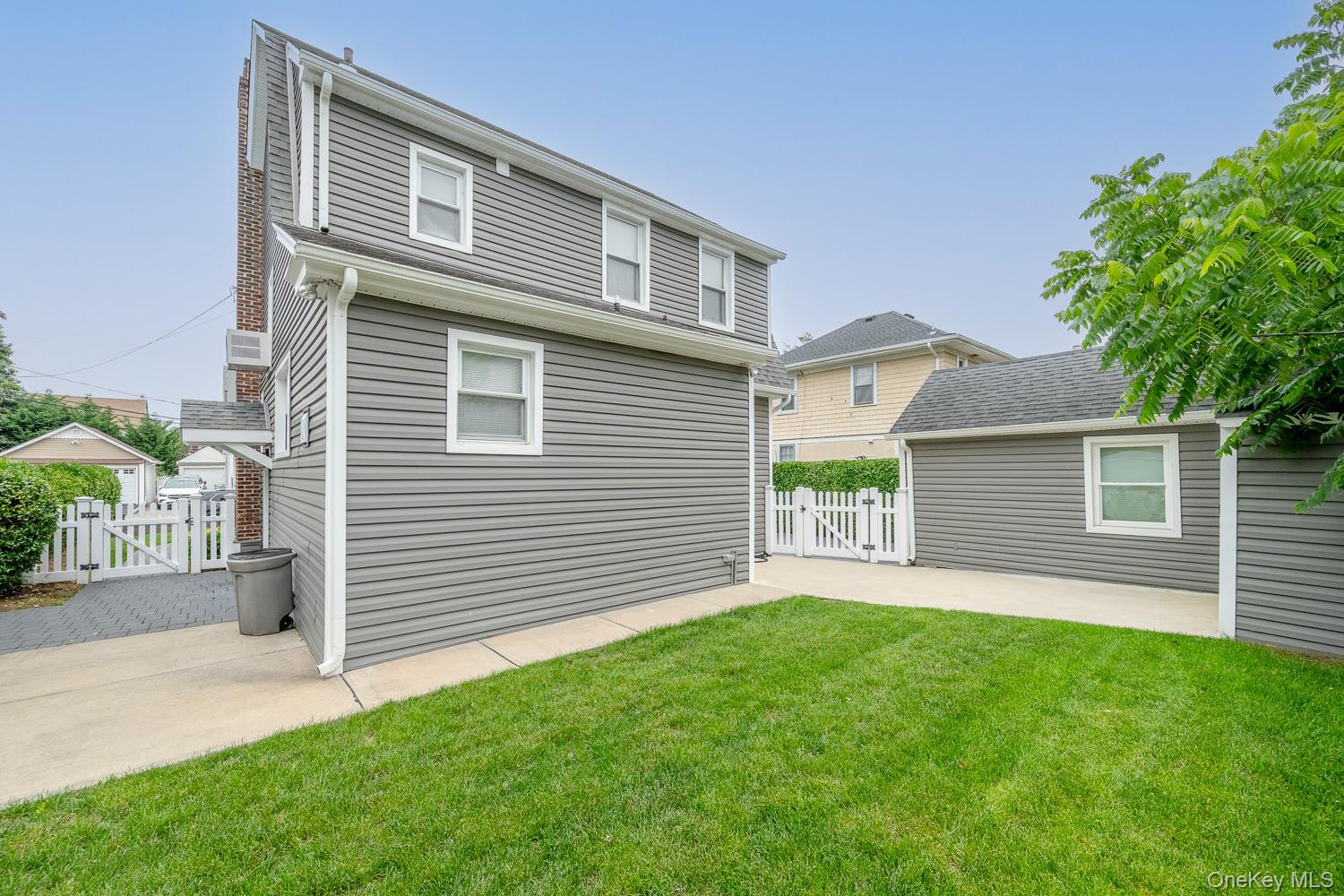 37 Keystone Place Hewlett, NY 11557 - Photo 41 of 45 a front view of a house with a yard and garage