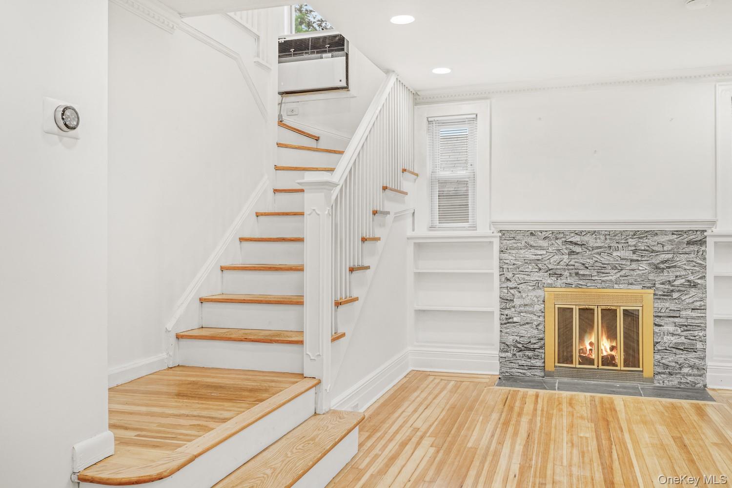 37 Keystone Place Hewlett, NY 11557 - Photo 6 of 45 a view of a livingroom with wooden floor and staircase