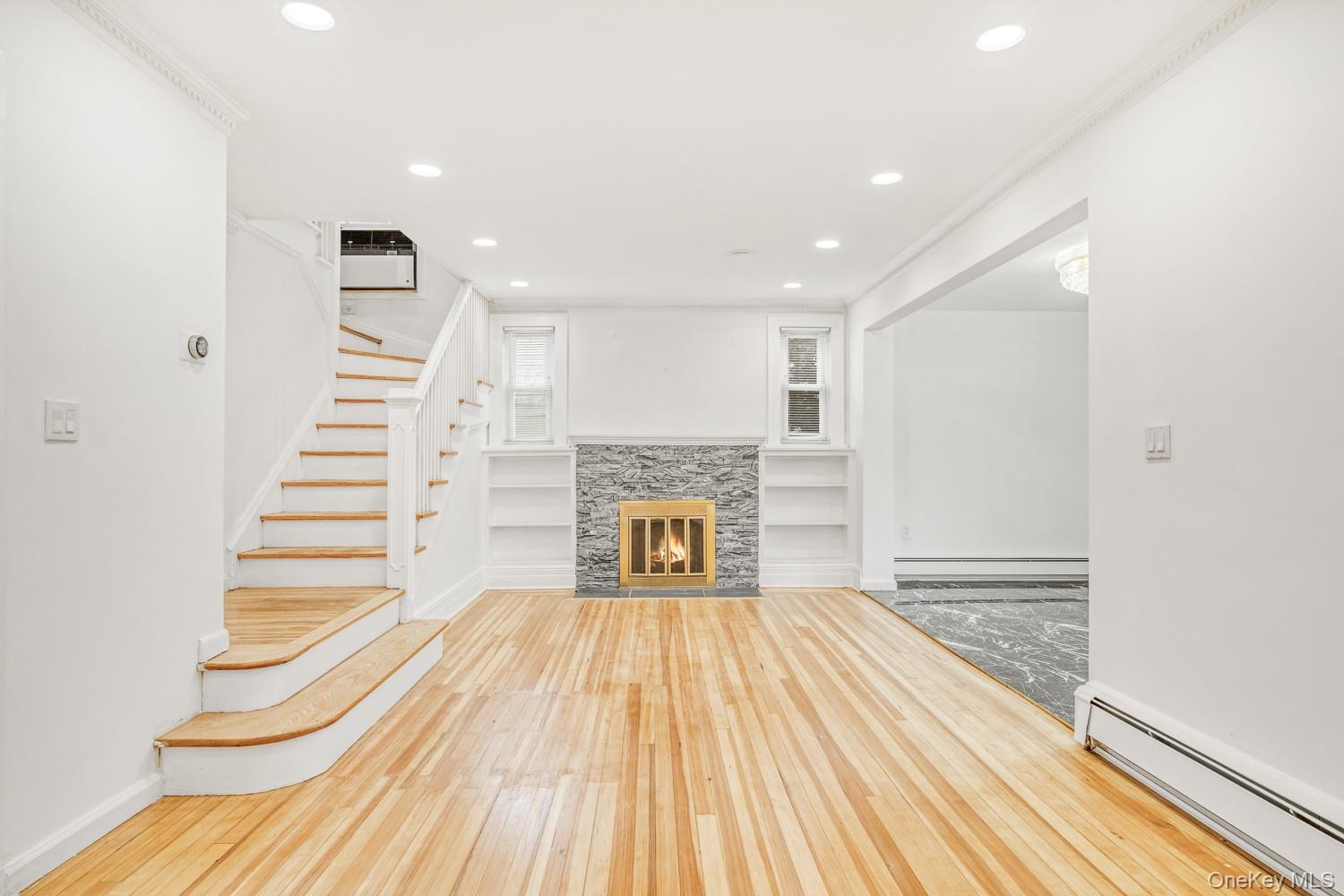 37 Keystone Place Hewlett, NY 11557 - Photo 8 of 45 a view of a livingroom with wooden floor and a fireplace