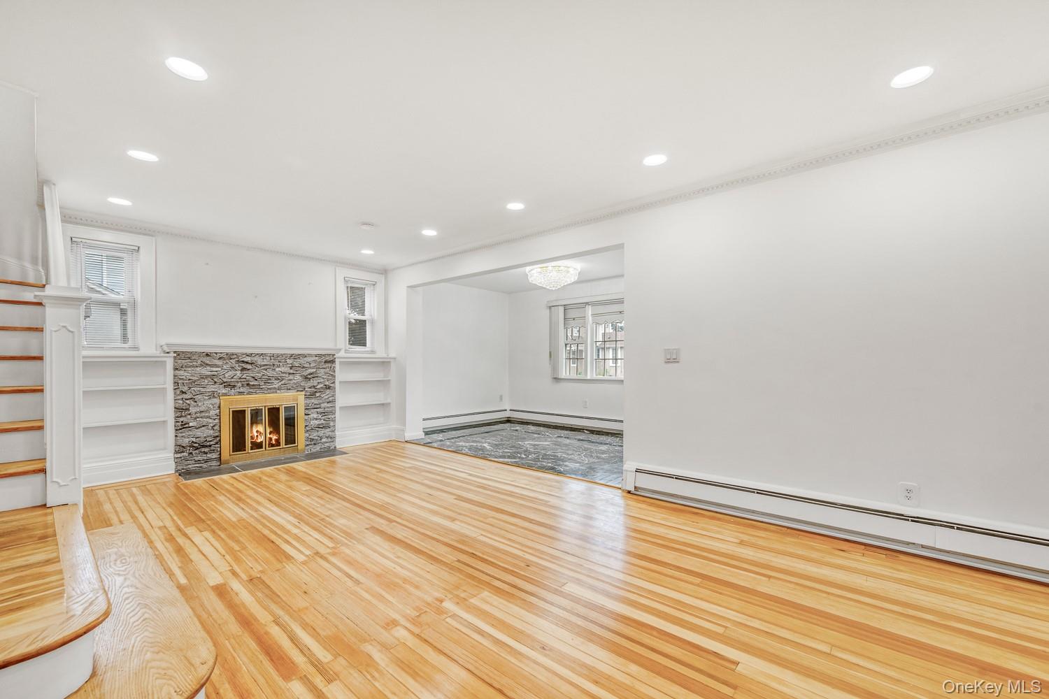 37 Keystone Place Hewlett, NY 11557 - Photo 9 of 45 a view of empty room with wooden floor and fireplace