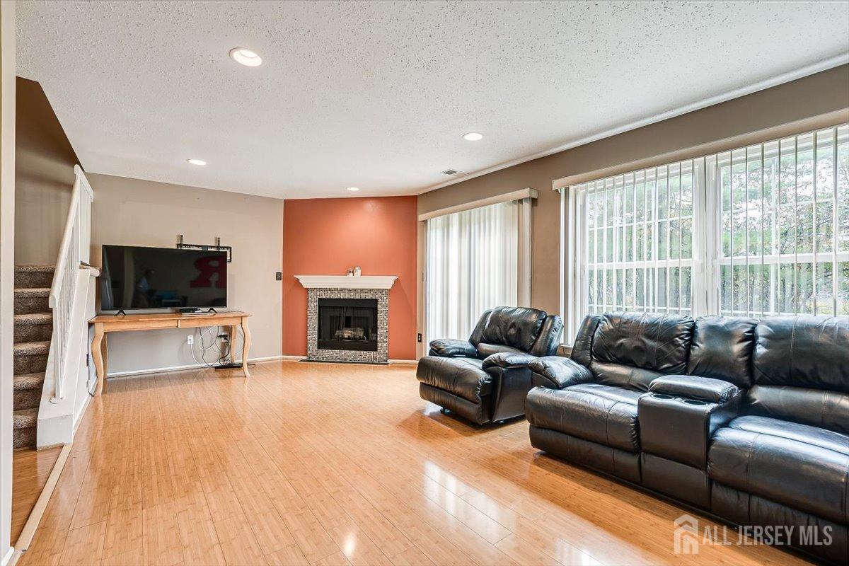 230 Nebula Road Piscataway, NJ 08854 - Photo 12 of 33 a living room with furniture a fireplace and a flat screen tv