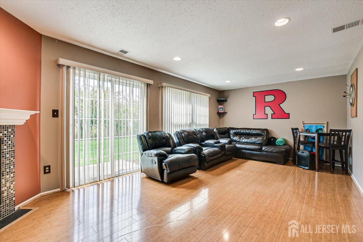 230 Nebula Road Piscataway, NJ 08854 - Photo 14 of 33 a living room with furniture a flat screen tv and a large window